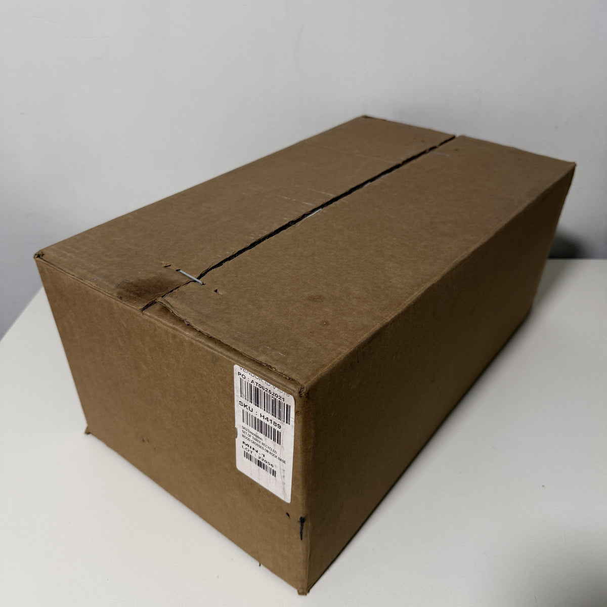 Shipping carton for the set of three wood crosses, taped seam and label