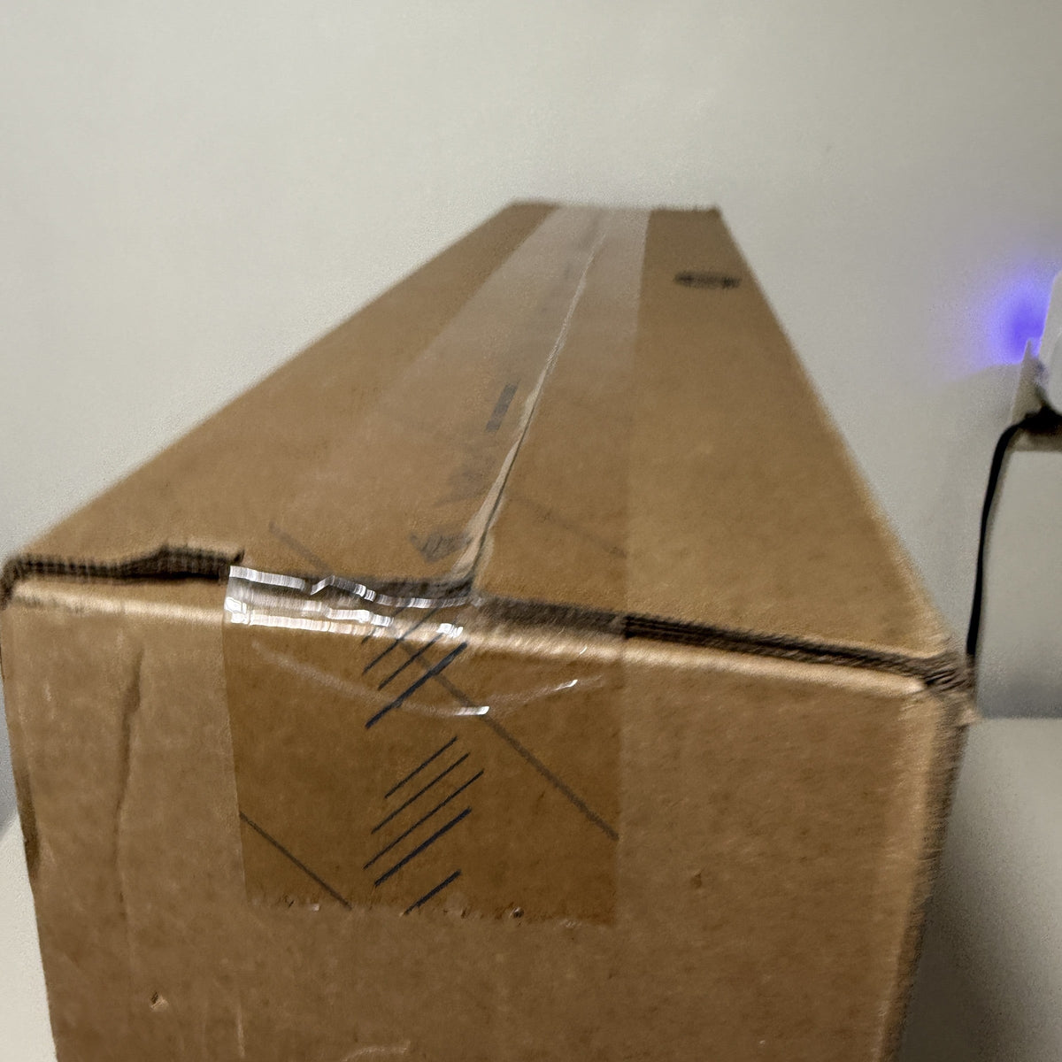 Factory tape along the top seam of the HP all-in-one carton