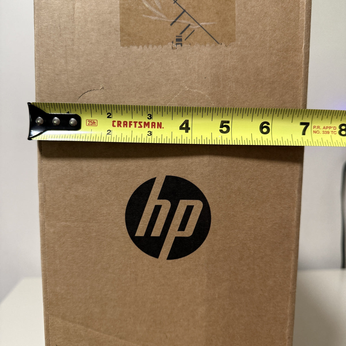 HP carton depth measured with a tape measure at about 7 inches