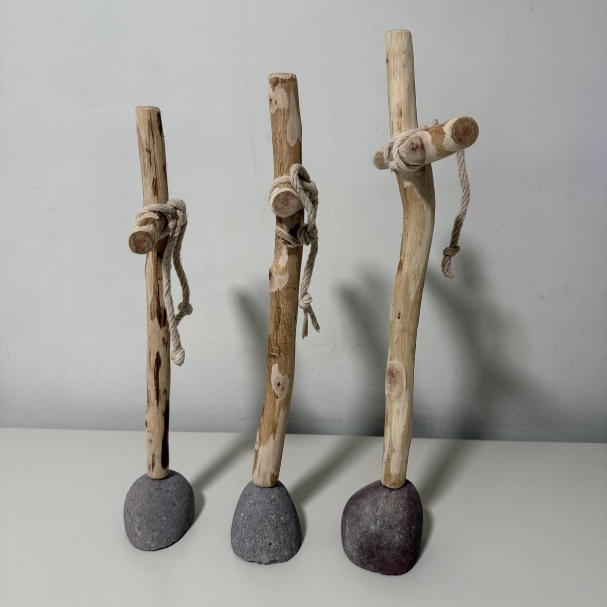 Back view of the three wood crosses on their rock bases