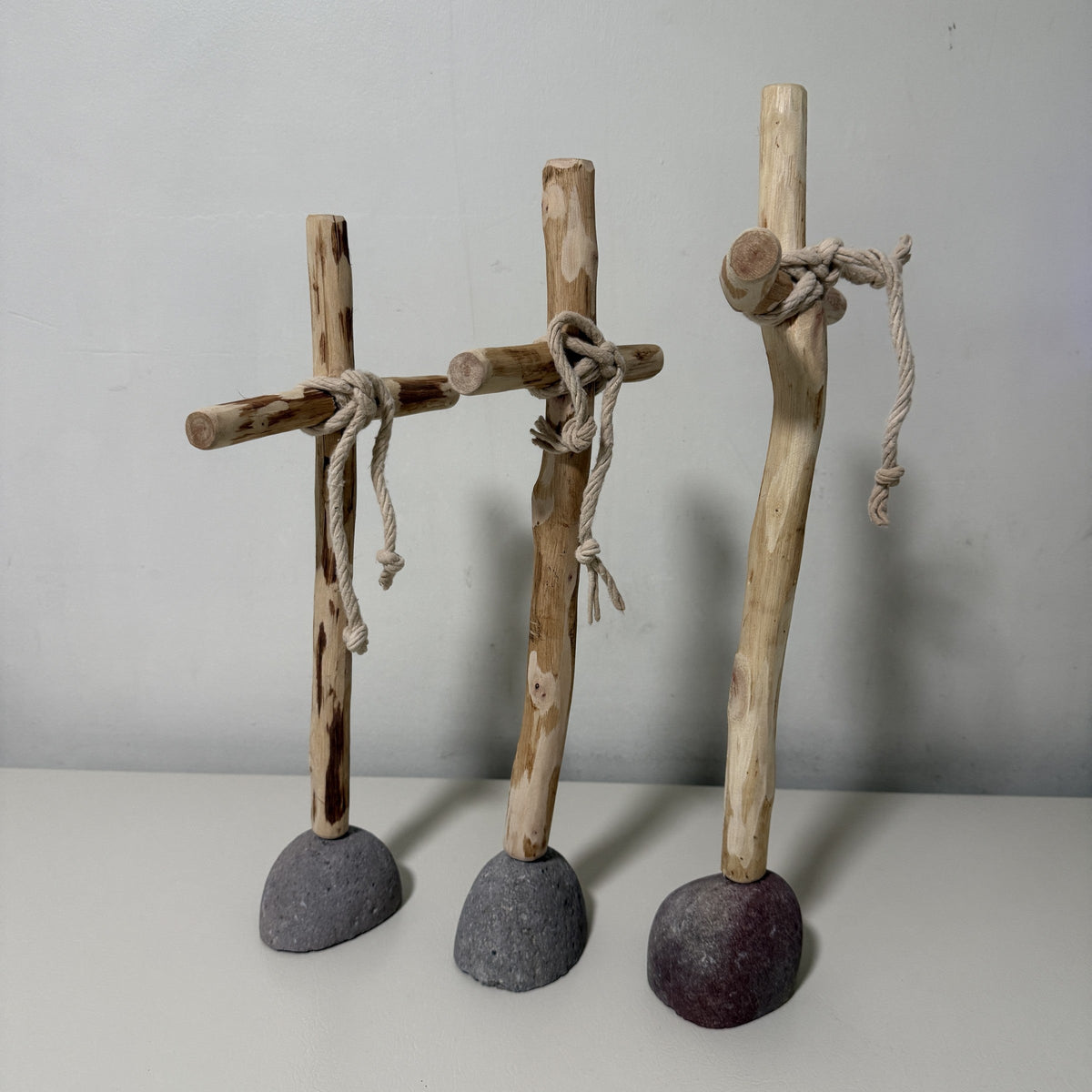 Three recycled wood crosses grouped together showing grain and knots