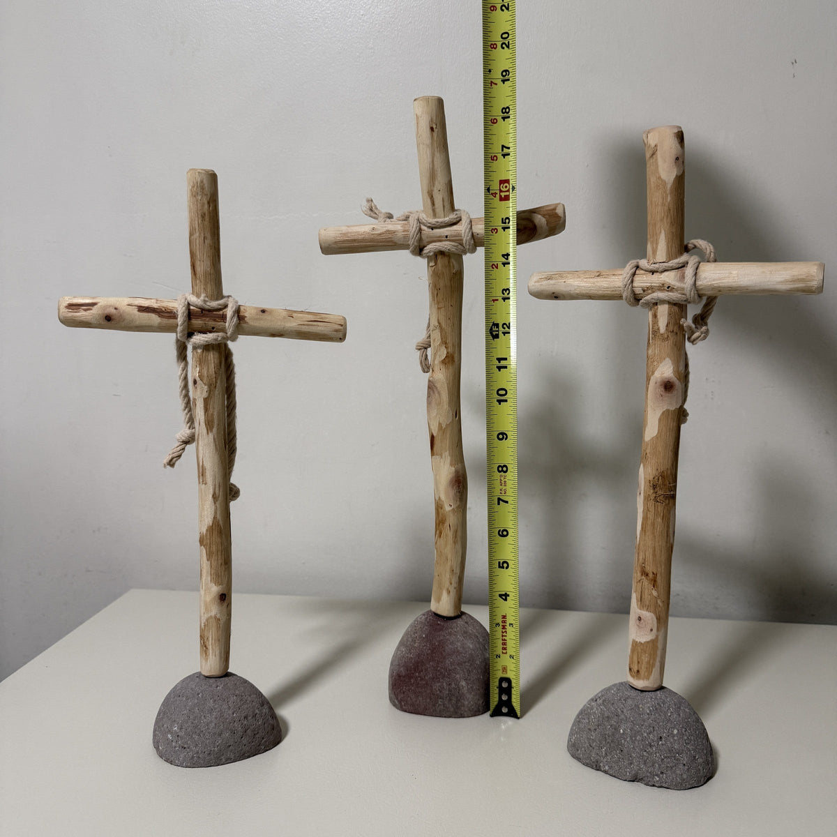 Wood cross height measured against a tape measure
