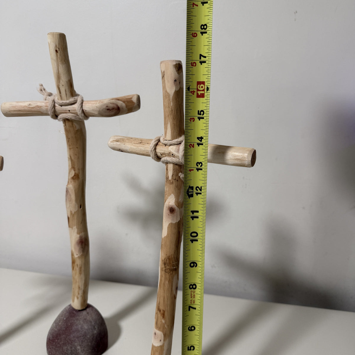 Tallest wood cross measured against a tape measure