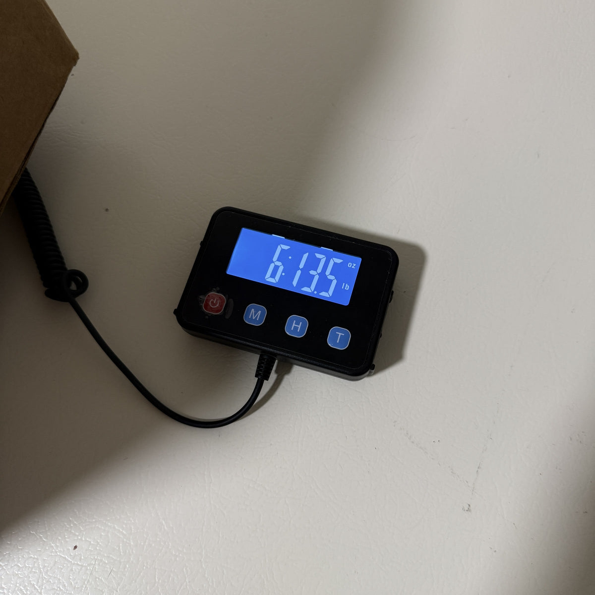Digital scale reading 6 lb 13.5 oz for the packed set of crosses
