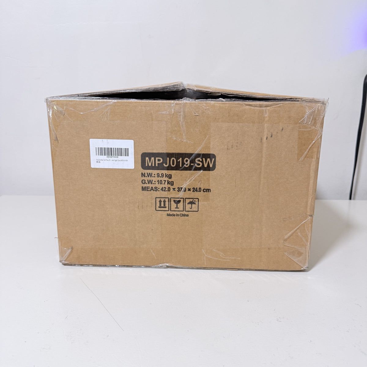 Hey-brother cat tree carton end panel showing net weight 9.9 kg, gross 10.7 kg and 42 x 37 x 24 cm